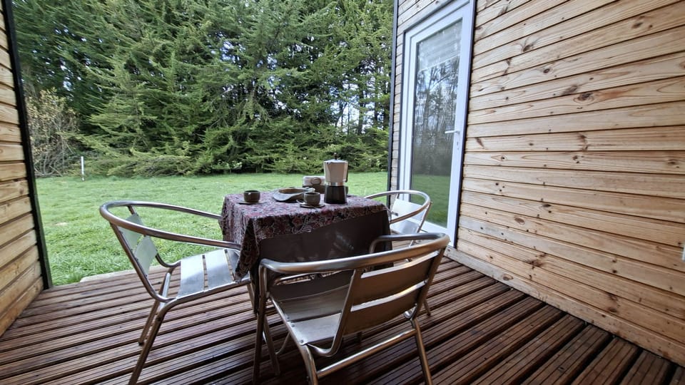 Outdoor dining on the deck, facing the forest