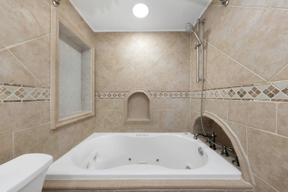 Second bathroom with the tub and a shower