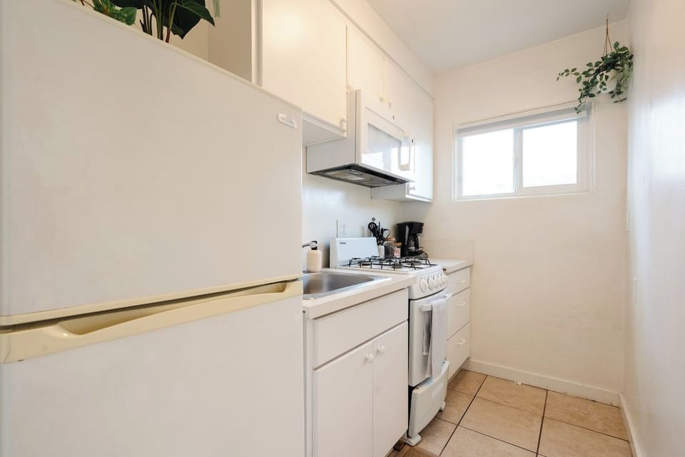 The charming kitchen comes stocked with all the essentials for your stay