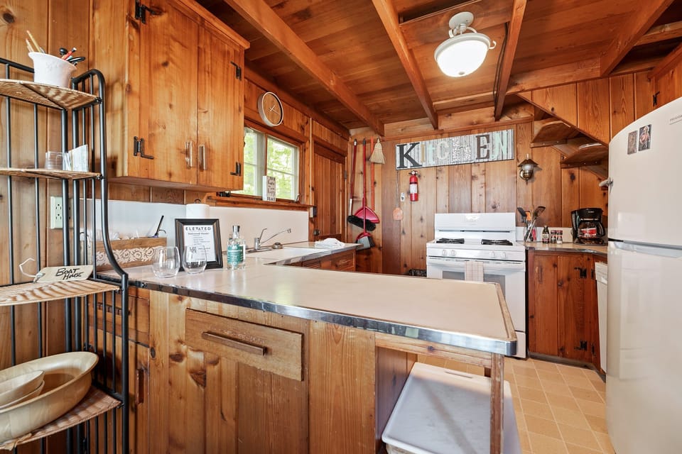 Freshen up in this bright, clean bathroom featuring a glass-enclosed walk-in shower, vanity with mirror, and convenient storage for your essentials.