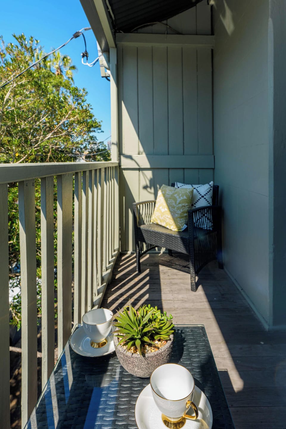 Savor morning coffee or evening drinks on a sunlit private balcony with comfortable outdoor seating and leafy neighbourhood views.