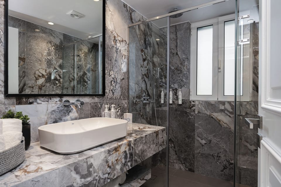 A sleek bathroom with walk-in shower and clean, contemporary finishes ensures a refreshing and comfortable stay experience.