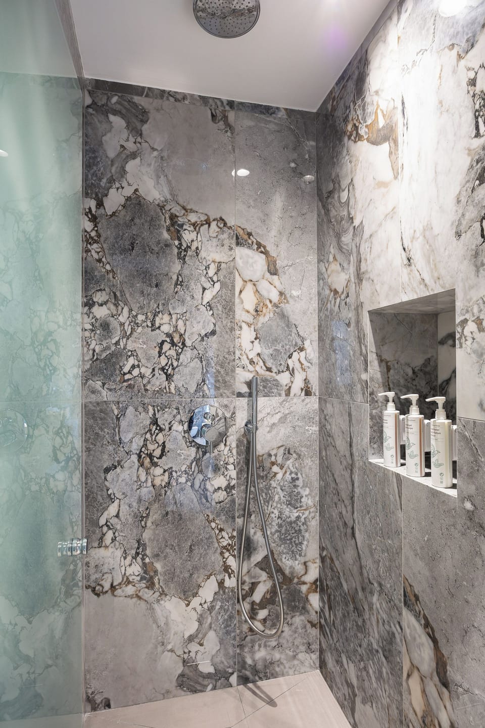 Modern bathroom with walk-in shower and premium amenities, designed for comfort and convenience.