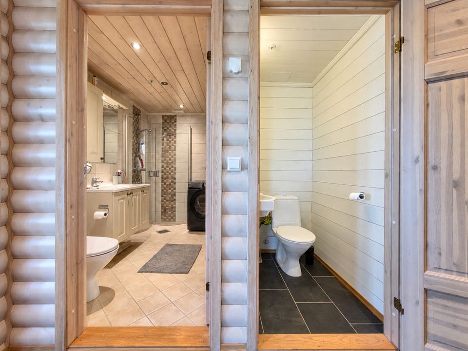 Bathroom with separate toilet with warm cozy wood feeling