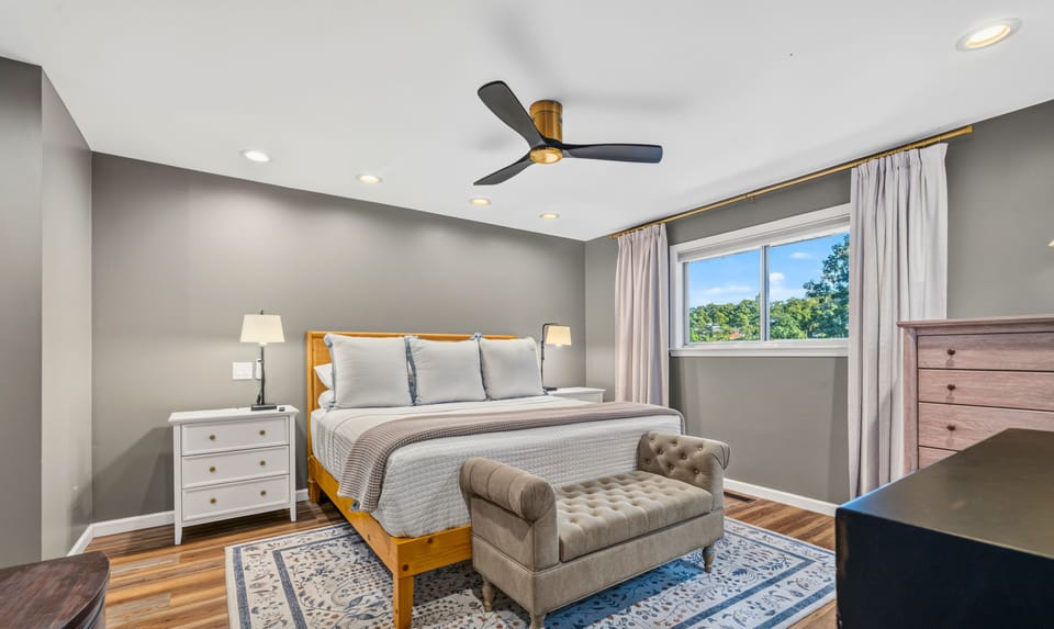 This spacious king room offers a comfortable place to recharge, with warm wood floors, soft neutral finishes, and plenty of room to settle in.