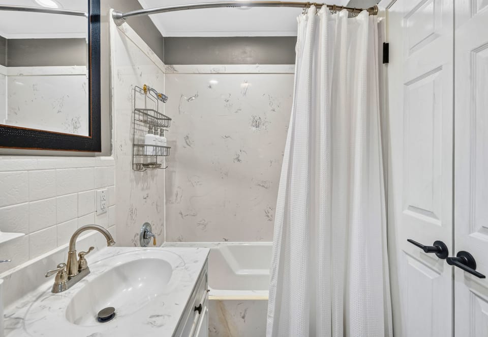 Choose between a relaxing soak in the tub or a refreshing shower, with both conveniently arranged within this bright and spacious bathroom.