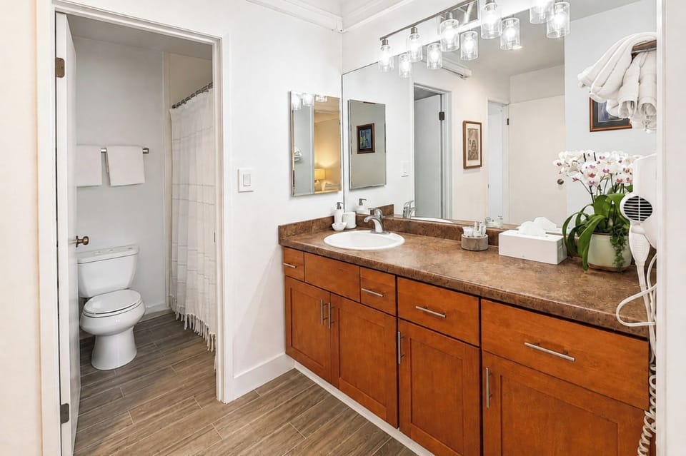 Primary bathroom vanity at Napili Point B31 — spacious counter space with a separate shower and tub room just beyond NAP-B31