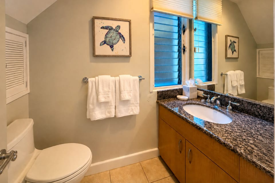 Your guest half bath features a spacious vanity and granite counter, conveniently located on the entry level. KBV-32B3