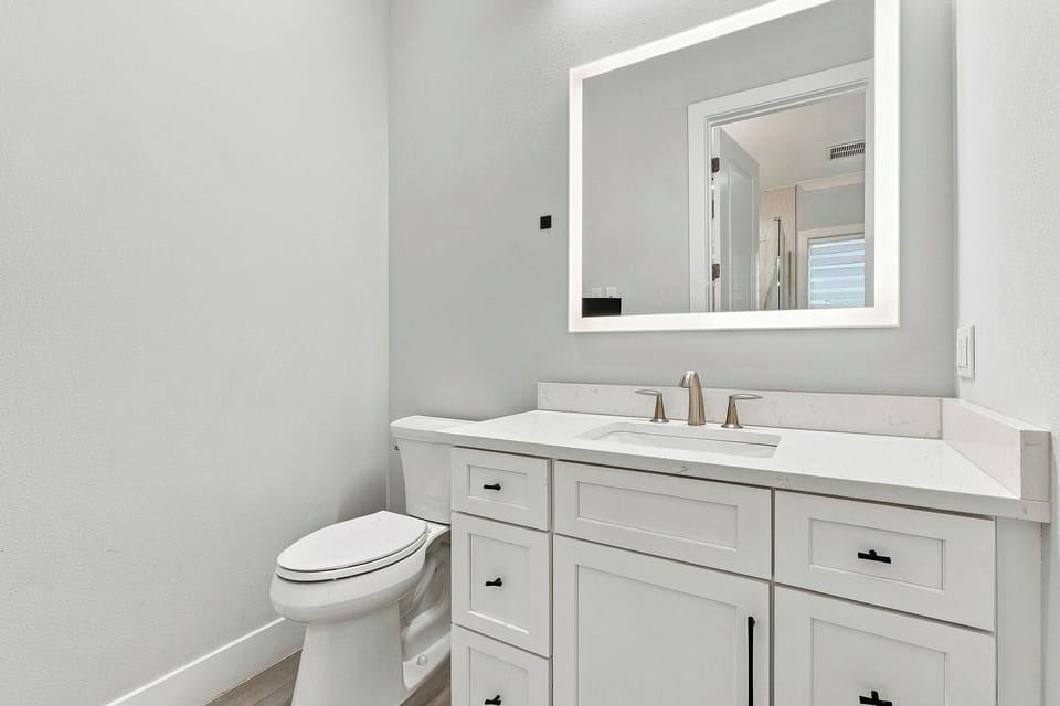 Water closet in the primary bathroom + tv