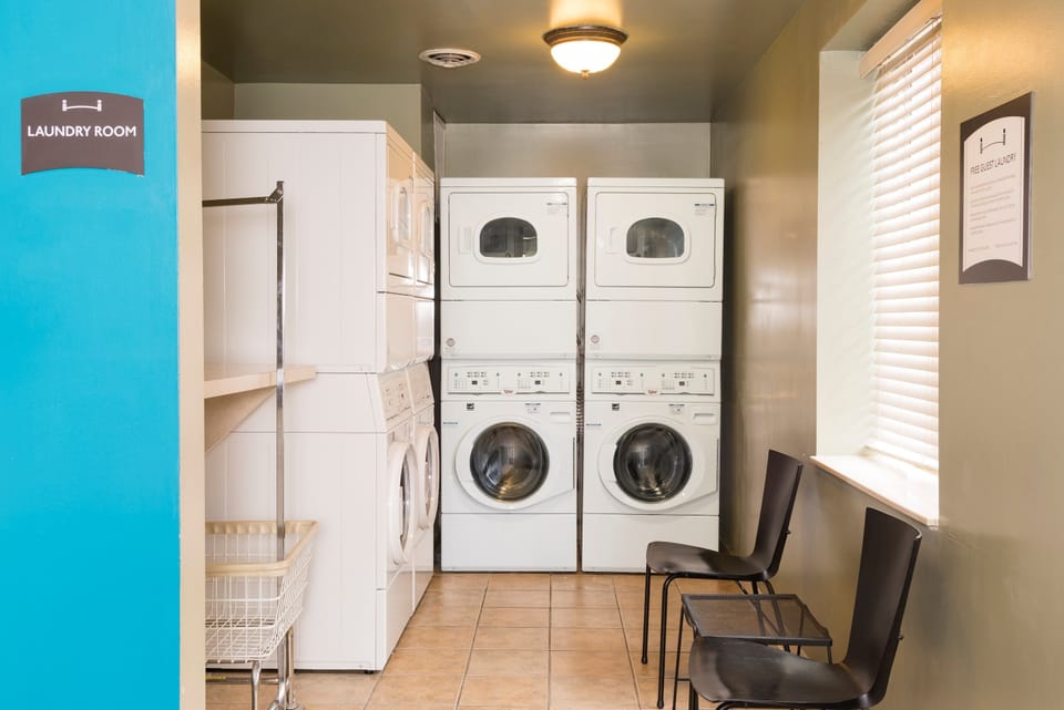 On-site laundry room with washing machines and seating.