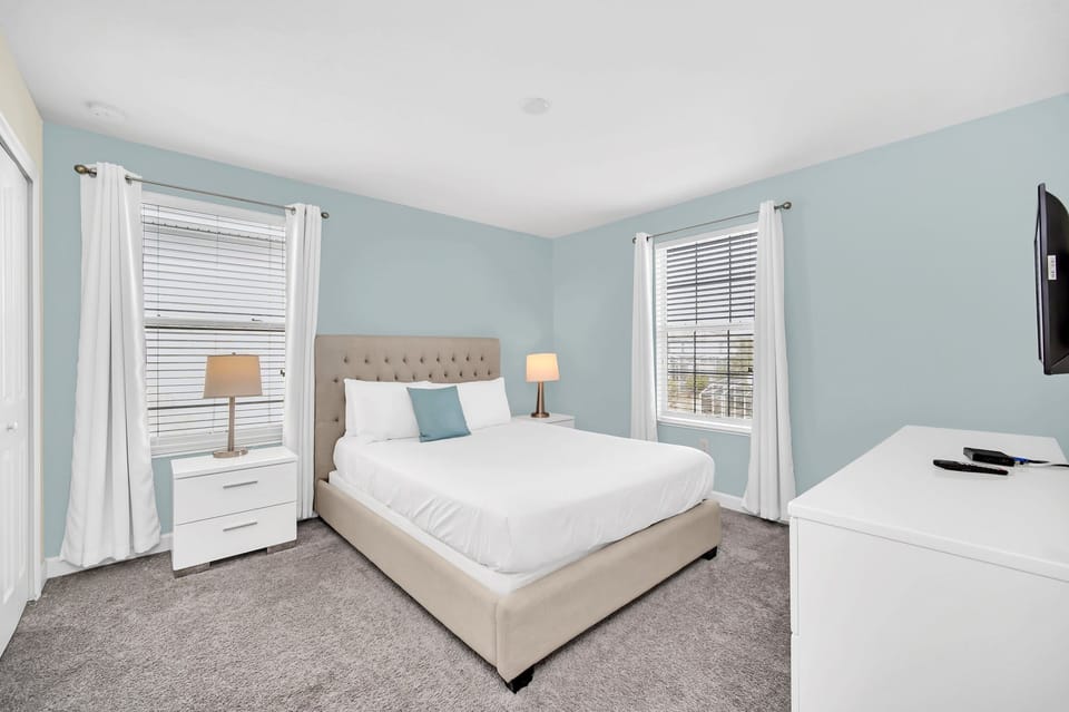 Comfortable guest bedroom featuring a queen bed and nightstand.