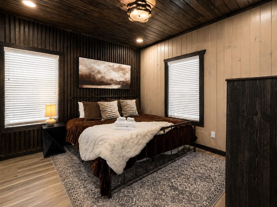 Cozy rustic bedroom with warm wood finishes and inviting modern comfort