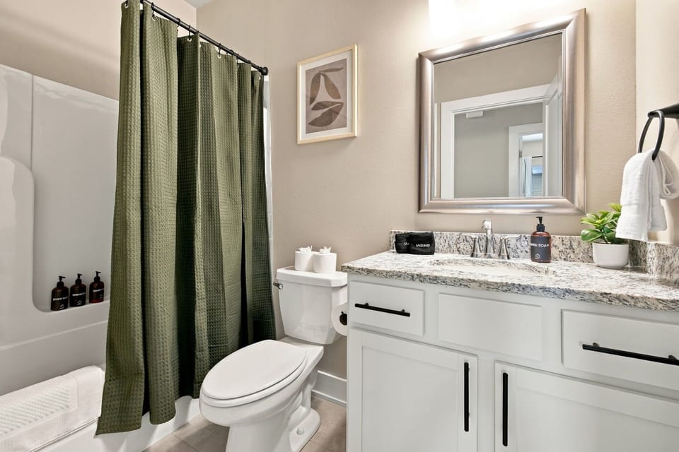 Shared bathroom located in the hallway.