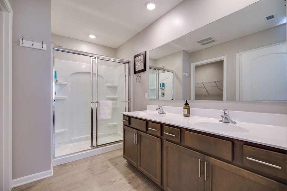 Stylish bathroom with double sinks and a sleek walk-in shower