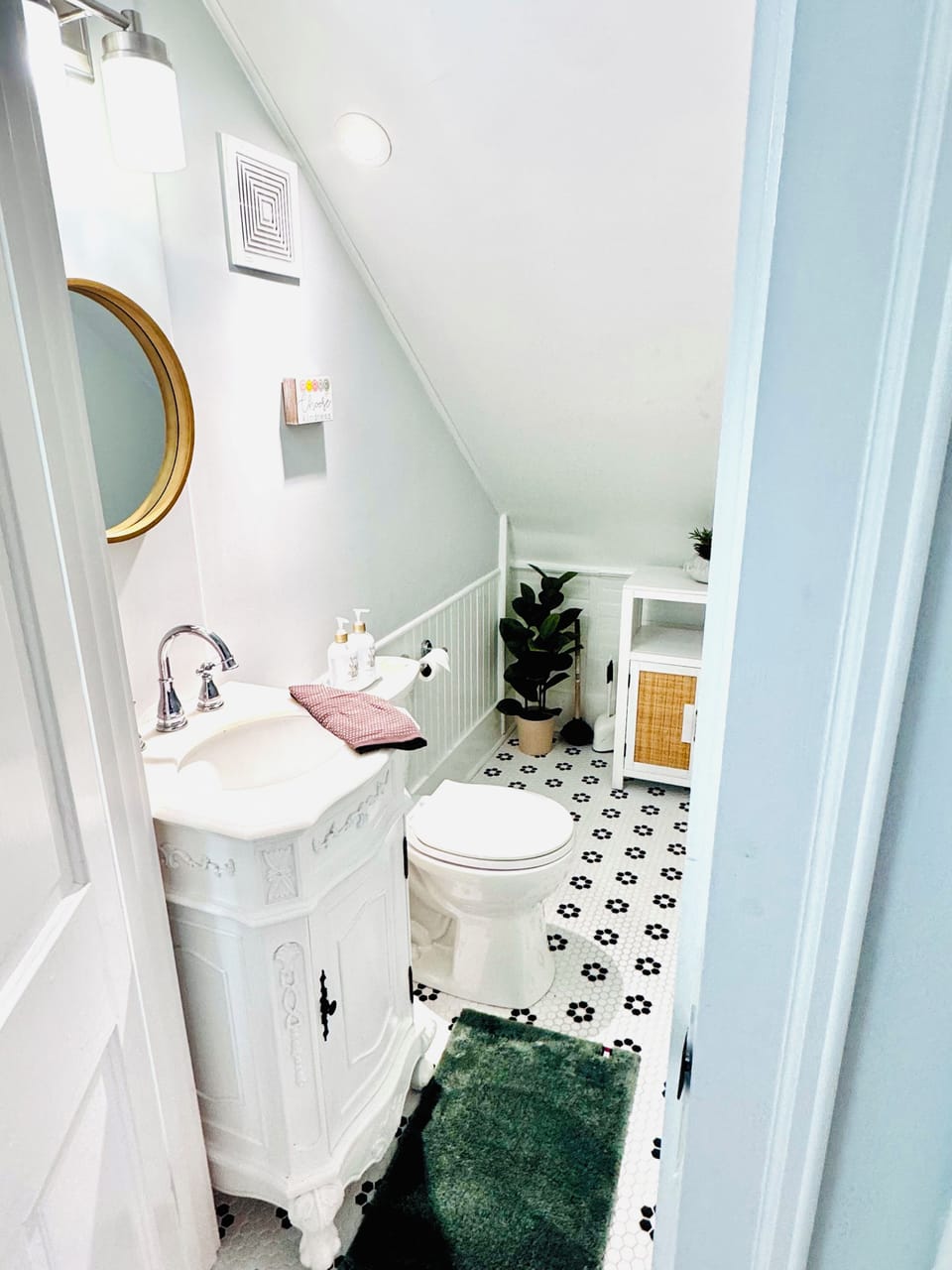 Separate toilet room with toiletries under sink and cabinet 