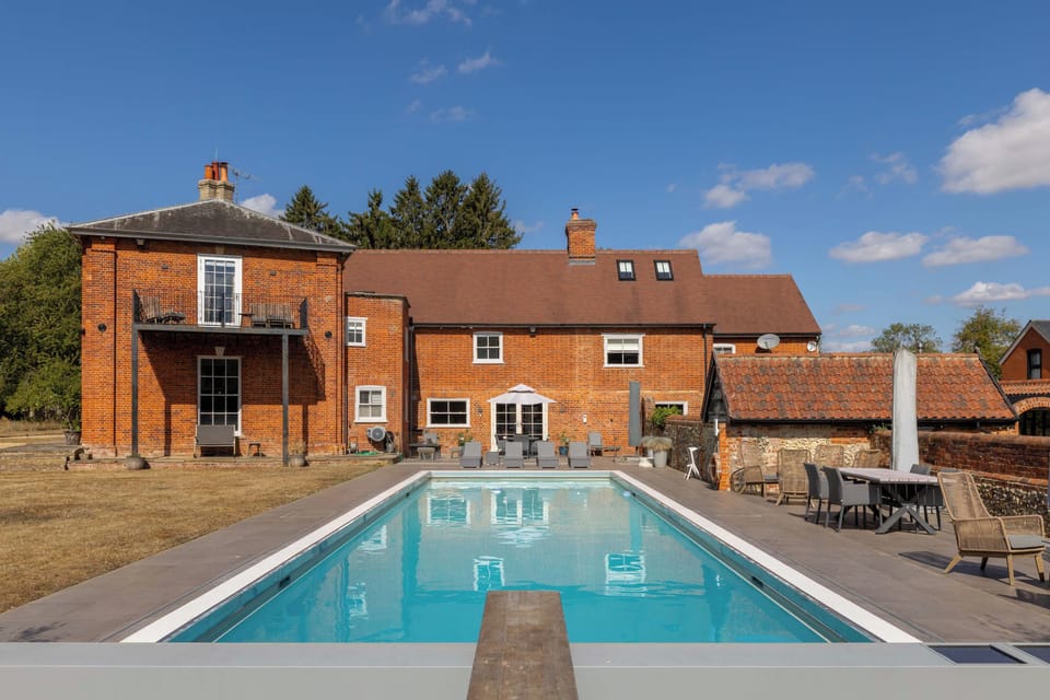 The pool and sun terrace with the wider grounds