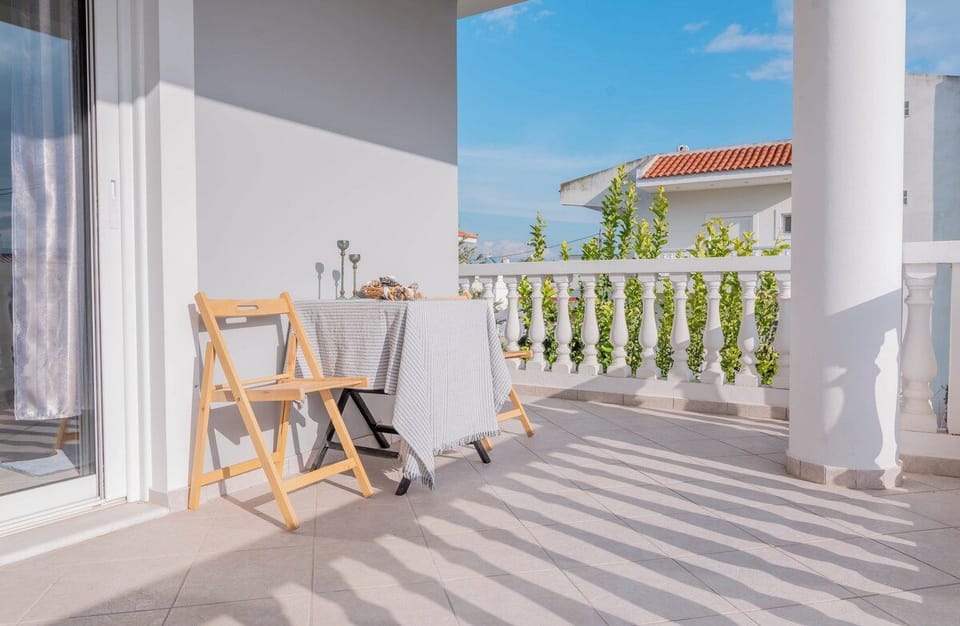 Sunlit balcony with outdoor seating
