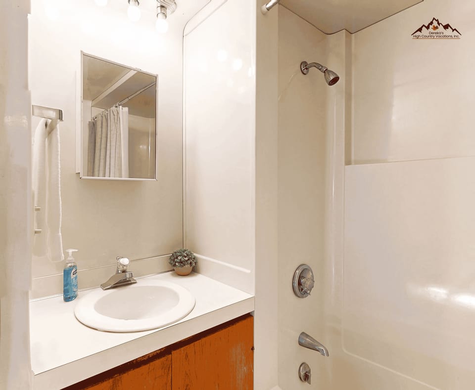 Your private bathroom awaits with a clean, modern design featuring a full tub-shower combo and ample counter space for your toiletries.