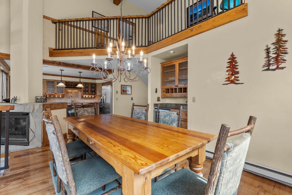 Gather around this beautiful handcrafted wooden table where your group can share meals and memories. The open layout connects you to the full kitchen and cozy living space, making it easy to stay together while cooking, dining, and relaxing.