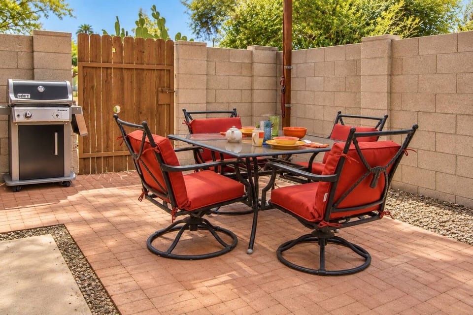 Shaded patio with BBQ grill and dining set