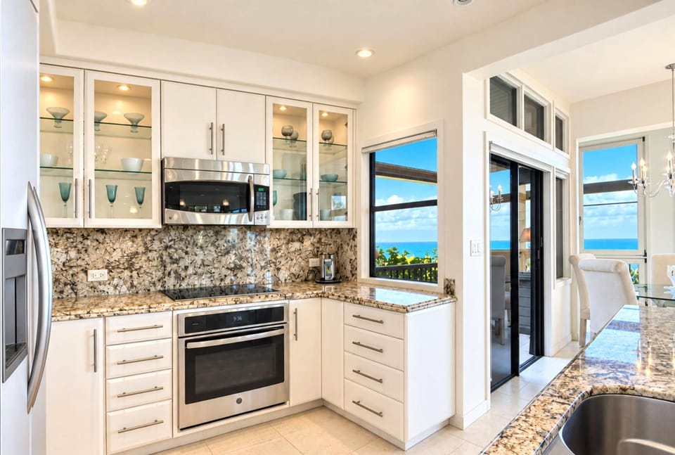 Primary ensuite bath with a glass block walk in shower and private water closet just steps from the dual sink vanity.