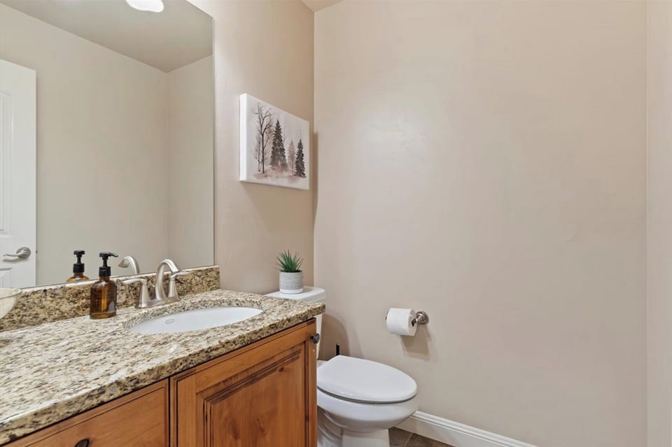 A stylish main-level half bath with modern finishes, offering convenience for guests and everyday living.