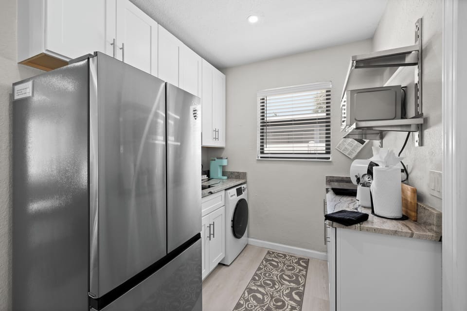 2nd kitchen in studio side. All in one washer & dryer. Full size refrigerator