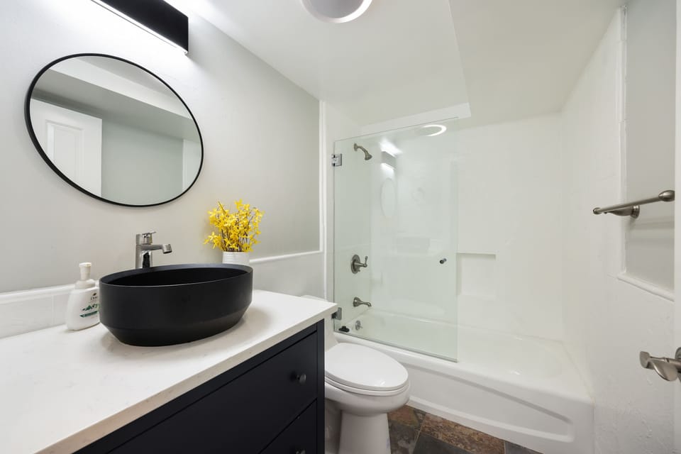 Full bathroom with bathtub and shower.