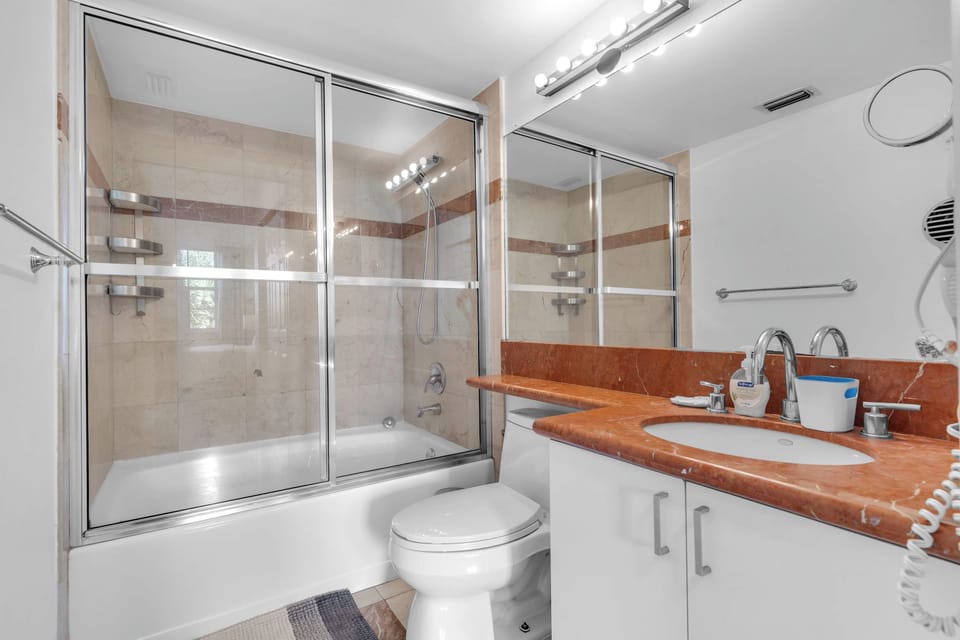 Wash up in the king ensuite, featuring a single vanity & shower/tub combo​
