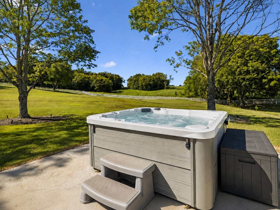 Hot Tub: Enjoy this expansive backyard retreat featuring a pool and alfresco kitchen, with plenty of space to swim, lounge, cook, and gather with family or friends.