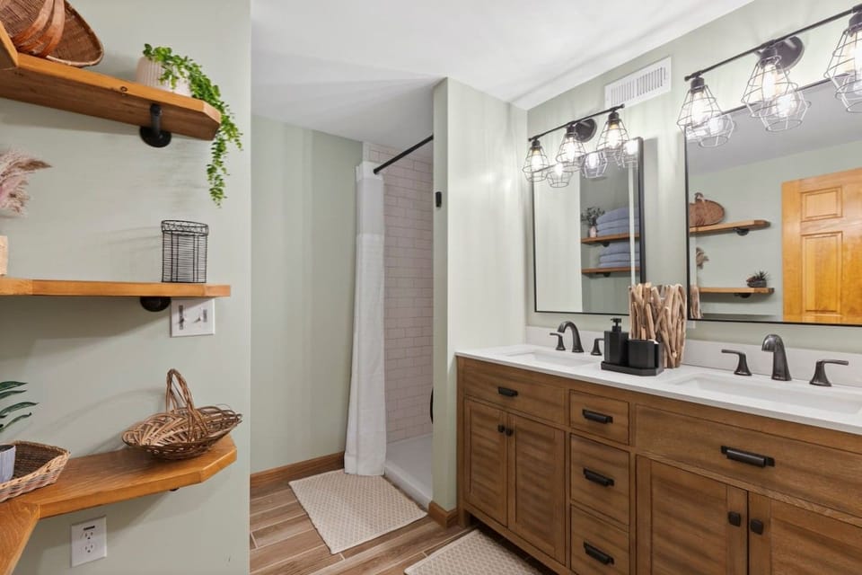 Full bathroom with a spacious vanity, walk-in shower, and bath essentials provided.