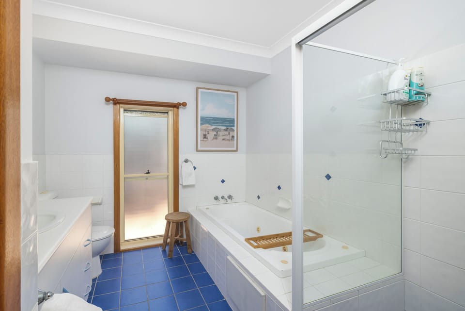 Bright bathroom with soaking tub, separate shower, and natural light
