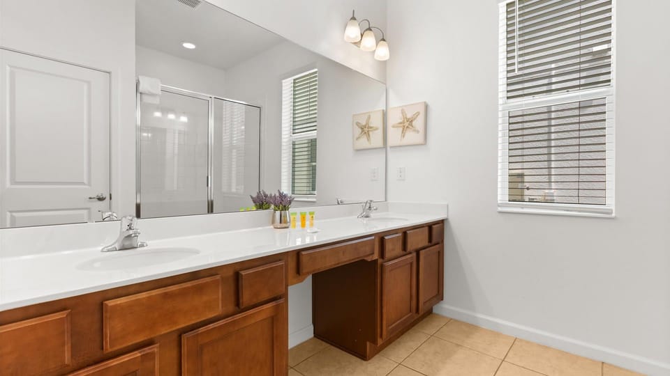 Enjoy plenty of space to get ready with a wide lighted mirror and modern double vanity.