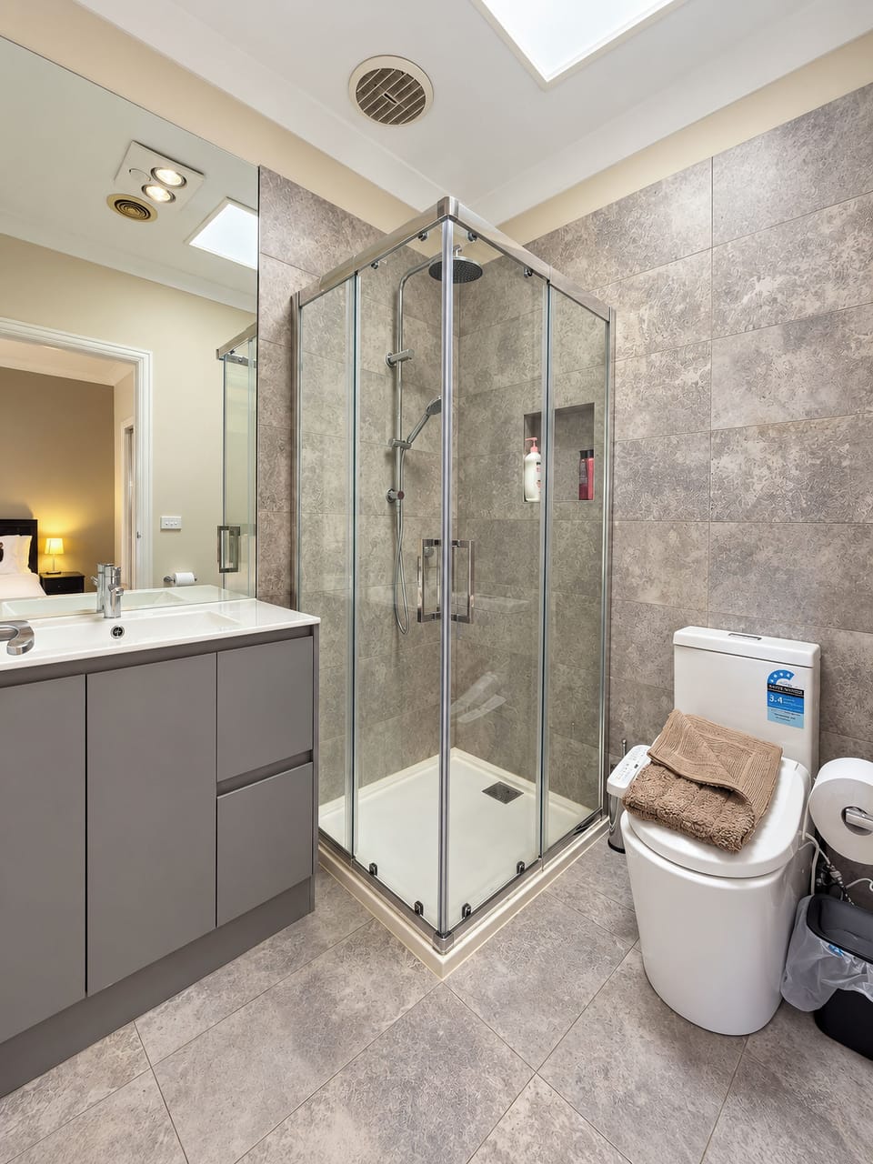 Bright modern bathroom with glass shower and sleek contemporary finishes