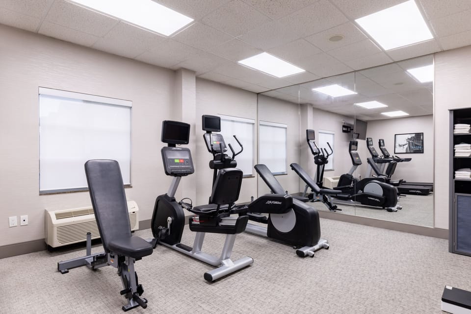 Fitness center with cardio machines and exercise equipment.