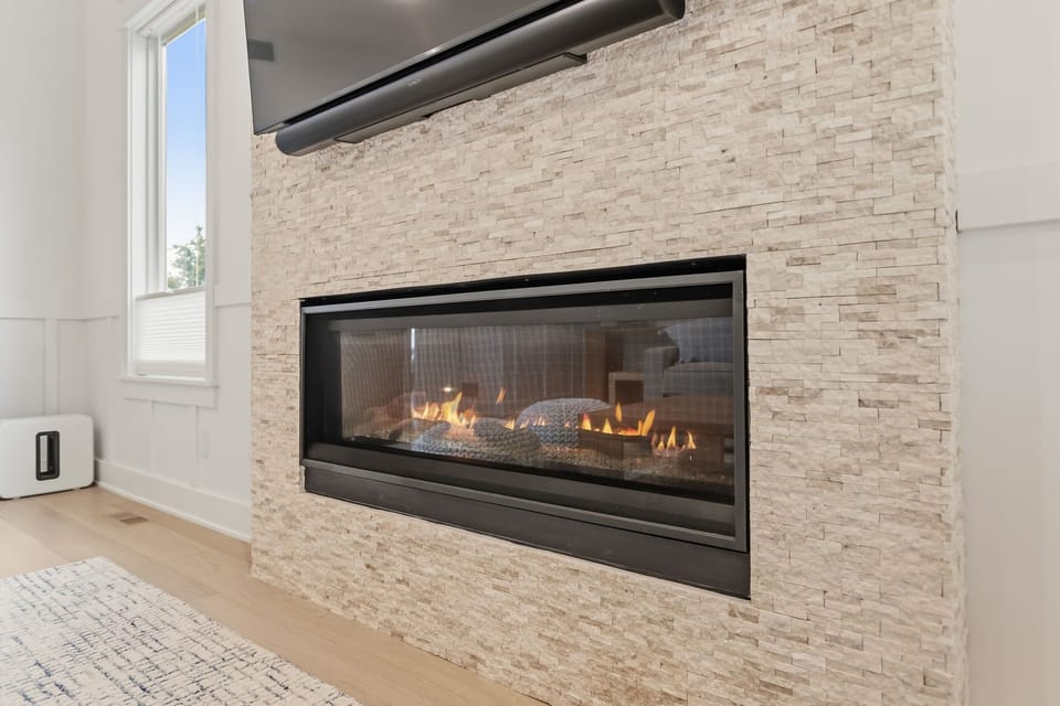 The fireplace creates a cozy gathering spot for cooler Michigan evenings