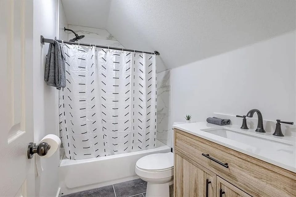 Bright full bathroom with a relaxing tub and clean, modern finishes.
