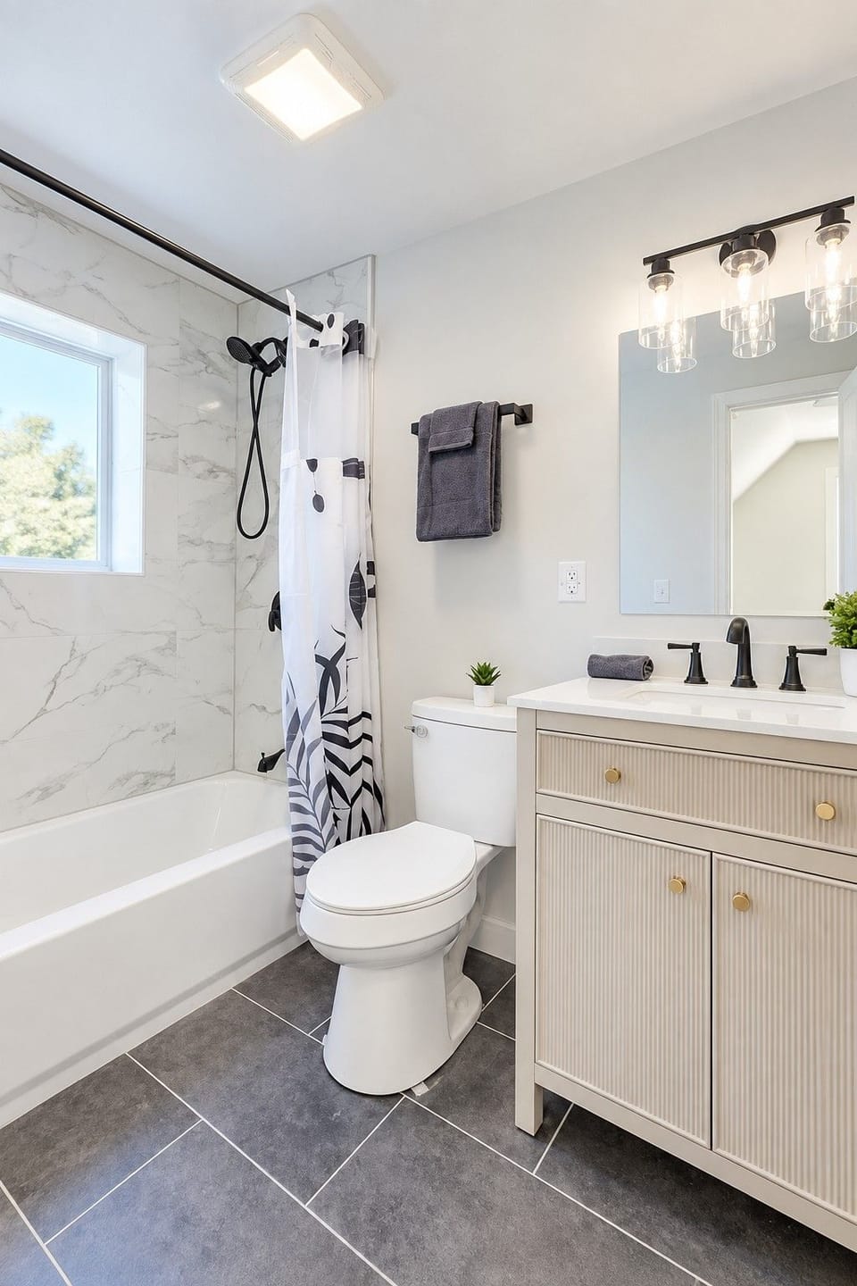 Bright full bathroom with a tub, modern vanity, and fresh, clean finishes.