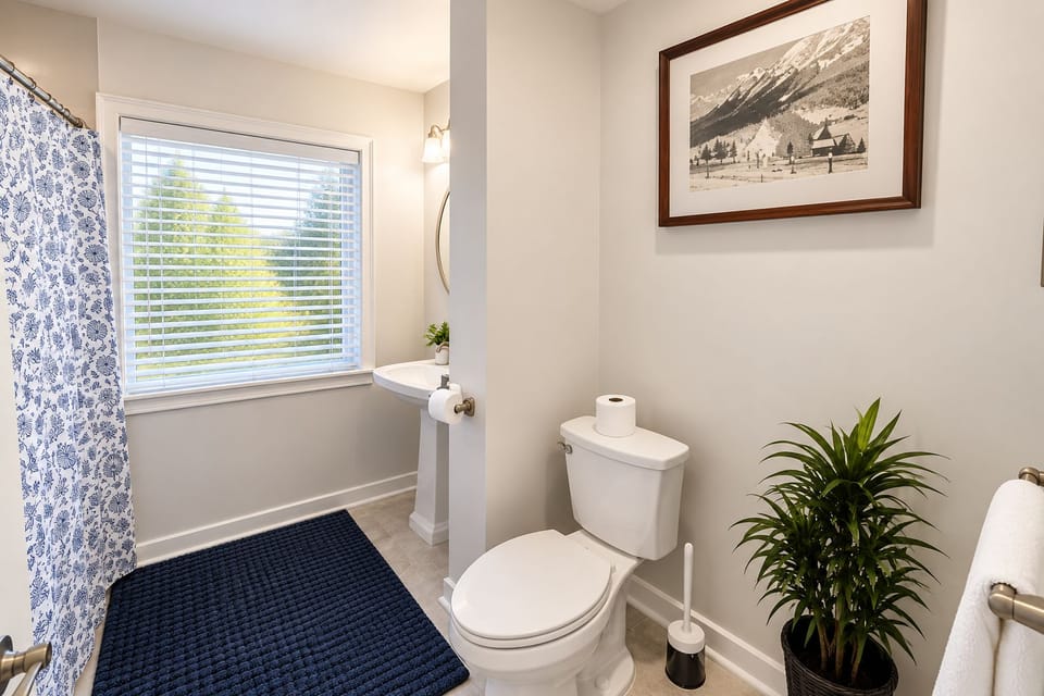 Classic bathroom with tub and framed artwork.