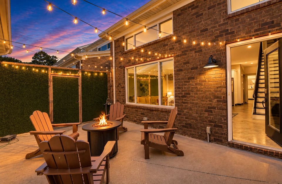 Grab a seat in these classic wooden Adirondack chairs for an evening under the twinkling string lights. The warm fire pit is ready for your late night stories.