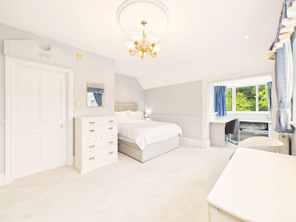 Settle into this restful bedroom with its own chest of drawers and a calming garden outlook for a proper night`s sleep.