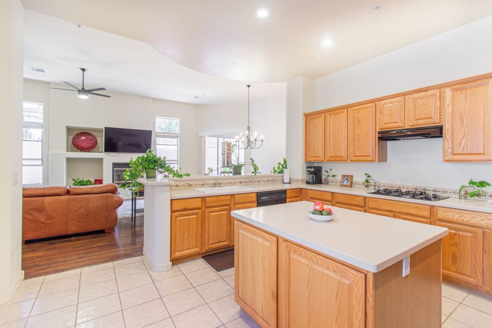 Bright open kitchen with large island flowing into a cozy living area