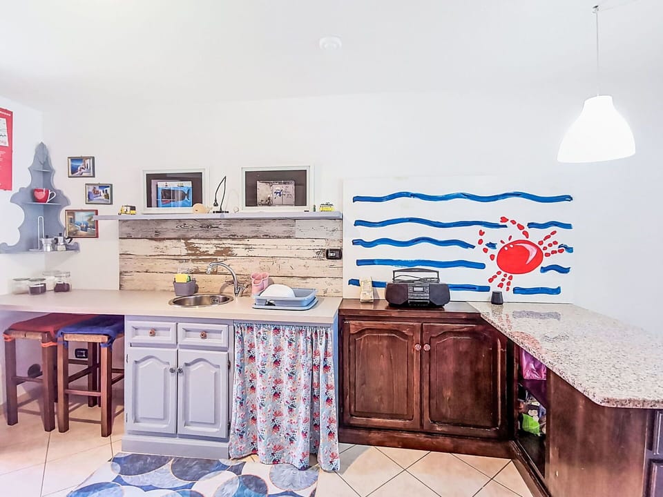 Interior Design, Furniture, Kitchen, Flooring, Countertop, Room, Cabinetry, Floor, Kitchen Appliance, Paint