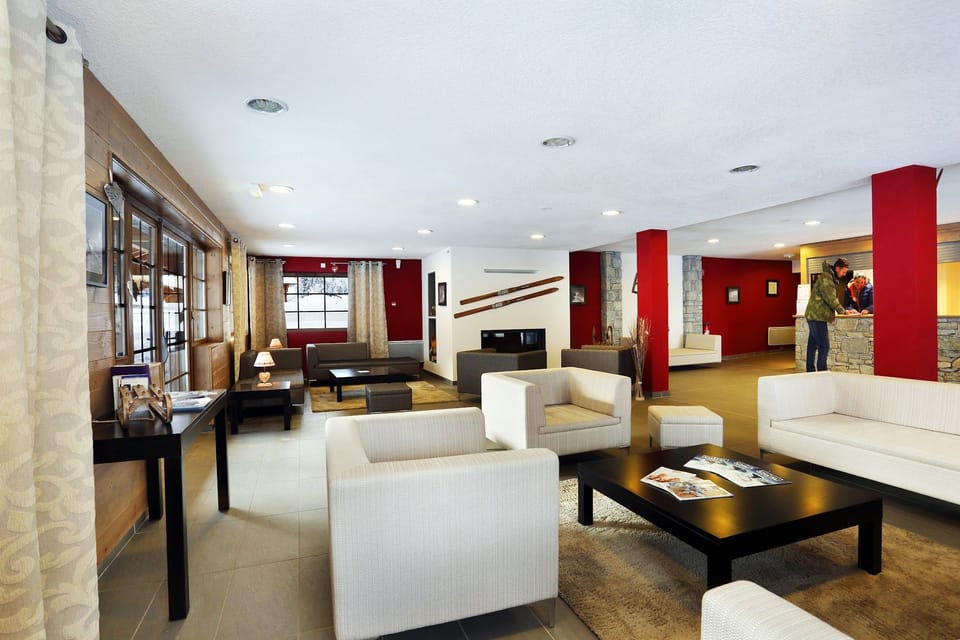 Reception seating area with large windows and curtains