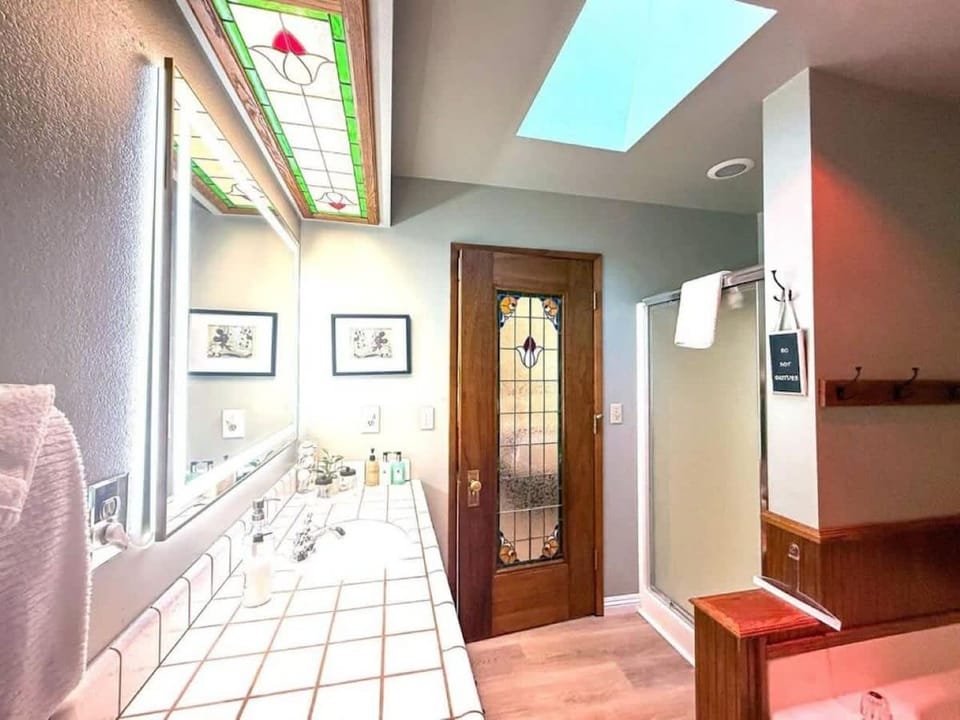 Upstairs bathroom with a shower and lighted mirror.