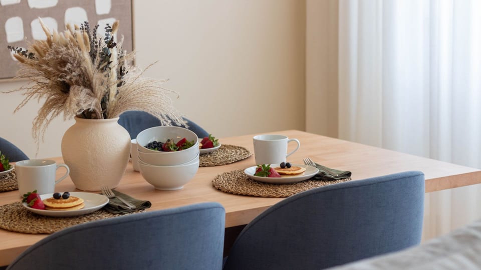 Relax in the inviting living room, where traditional shutters frame views of the city, offering a blend of comfort and local charm.
#LivingRoom #CityView #LovelyStay
