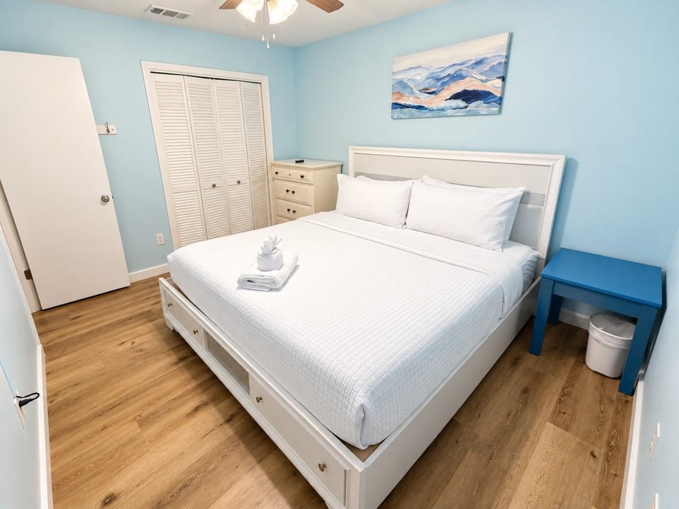 Airy primary bedroom in soft coastal blues