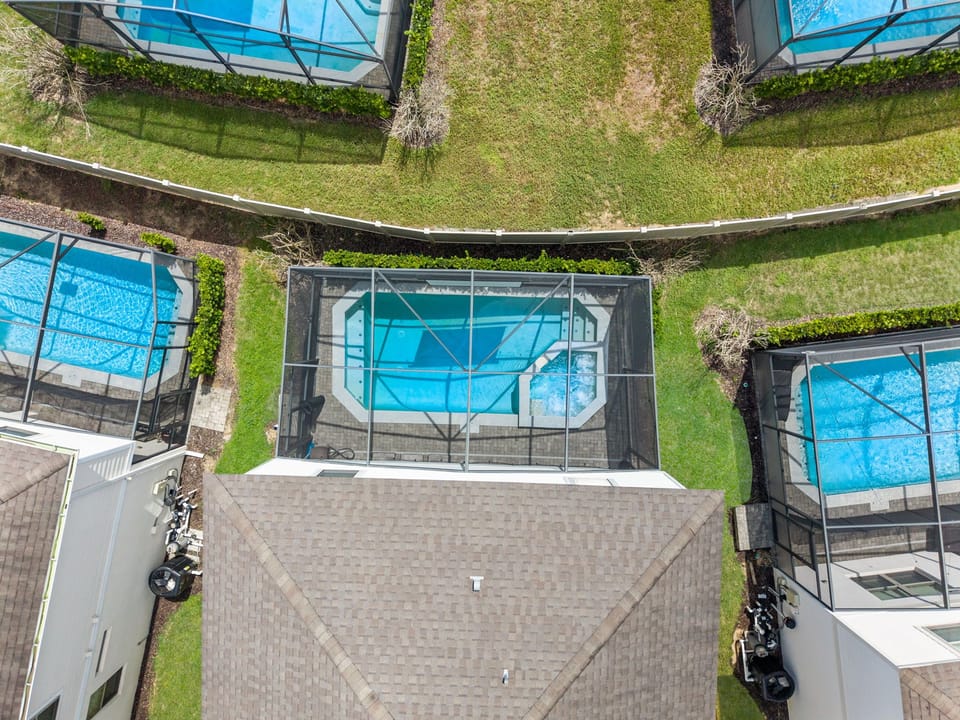 From above, the assignment is wonderfully clear: swim, soak, relax and repeat. The screened pool and spa create a private backyard oasis reserved entirely for your group.