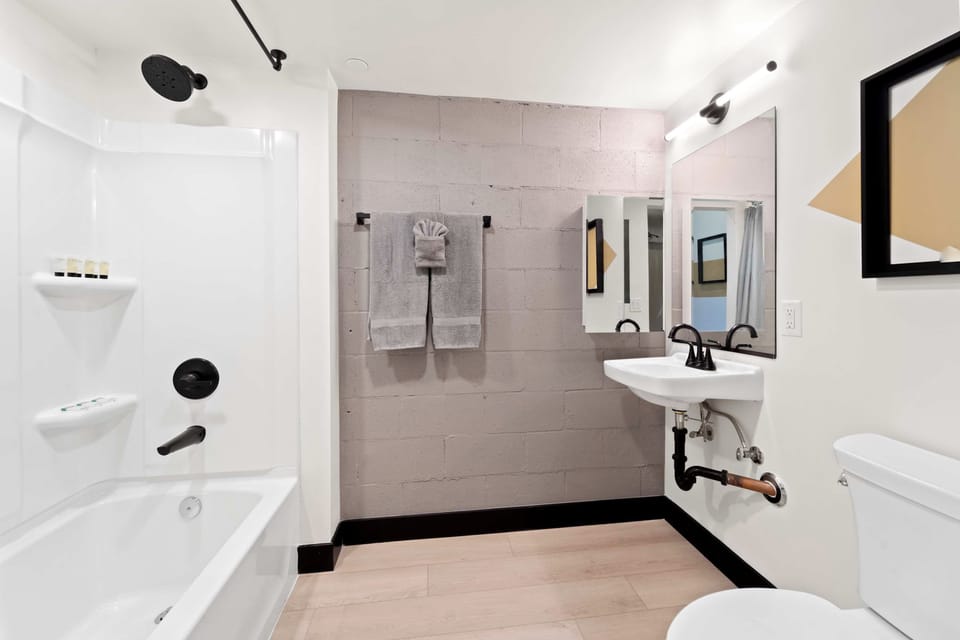 🛁 Clean, modern bath with a full shower-tub combo—simple comfort to start and end your day.