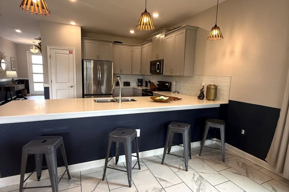 Kitchen with large counter and barstools